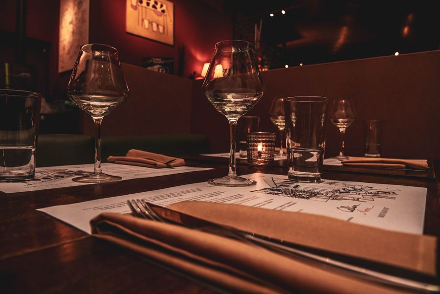 Candlelit restaurant table set for dinner